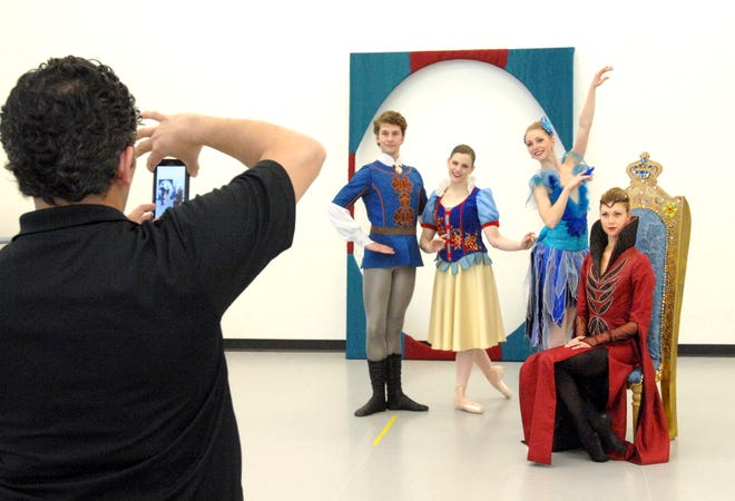 Peoria Ballet artistic director Servy Gallardo photographs dancers in their new Snow White costumes at the ballet's studios recently. Dancers are, from left, Lark Commanday, the prince; Katie Hallandsworth, Snow White; Allexe Slevin, a bird; and Alexandra James, the queen.