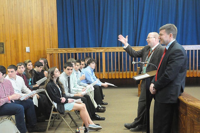 Taunton High social studies department head Peter Gillen, left, and Mayor Thomas Hoye Jr. welcome students at City Hall at the start of Good Government Day in Taunton.