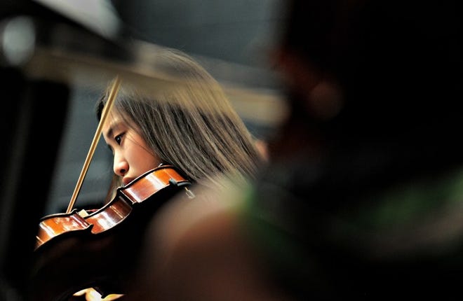 Cristea Park plays her violin during the 25th anniversary of Bucks County Music Educators String Day concert performed for family and friends at Newtown Middle School on Saturday.