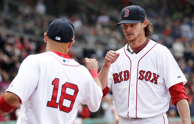 Boston Red Sox starting pitcher Clay Buchholz, right, fist bumps with right-fielder Shane Victorino while leaving the field after losing his no hitter in the eighth inning of a baseball game against the Tampa Bay Rays at Fenway Park in Boston Sunday, April 14, 2013.