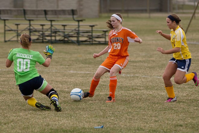 Quincy's Mackenzie Moore puts a shot on Hillsdale keeper Whitney Hodge on Monday. Jim Drews Photo