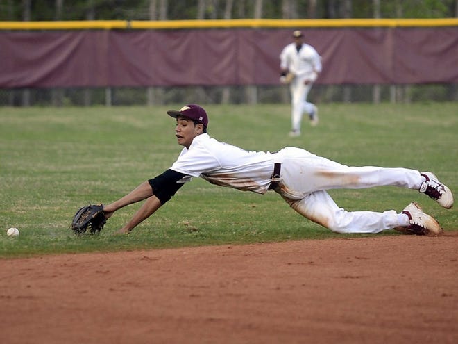 Woodruff’s Braxton Peavy dives but can’t quite reach a grounder against St. Joseph’s on Monday evening at Woodruff.