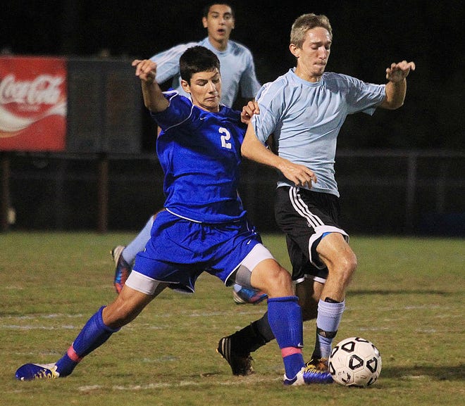Swansboro’s Ian Cole, right, fights for the ball during a game against Richlands last season. Cole said he is excited to be playing in the East-West all-star game in July.
