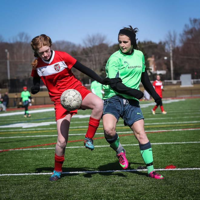 (3/17/13, MILFORD, MA) From left, Franklin's Kendyl Ryan of team JSSA Magic and Medway's Kenzie Coakley of the Scorpions fight for the ball during the soccer jamboree at Milford High School on Sunday. Photo by Dan Holmes