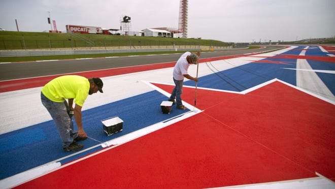 Drew Blackbird, left and Tommy Nelson paint fresh stars on the Circuit of the Americas on Tuesday. The track will be the site of a MotoGP race on Sunday.