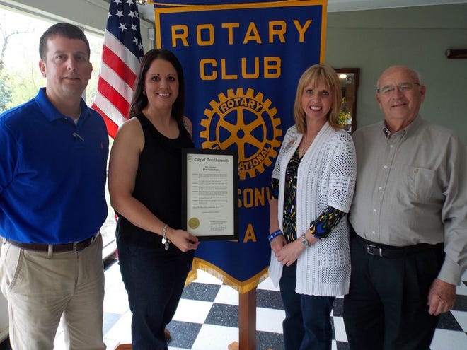 Rotary Club member Troy LeBoeuf (left) stands with Trish Castrogovannie, a mother of an autisic child, Jami Tindle, the executive director of Families Helping Families in Baton Rouge, and Rotary Club member Dave Dubreuil.