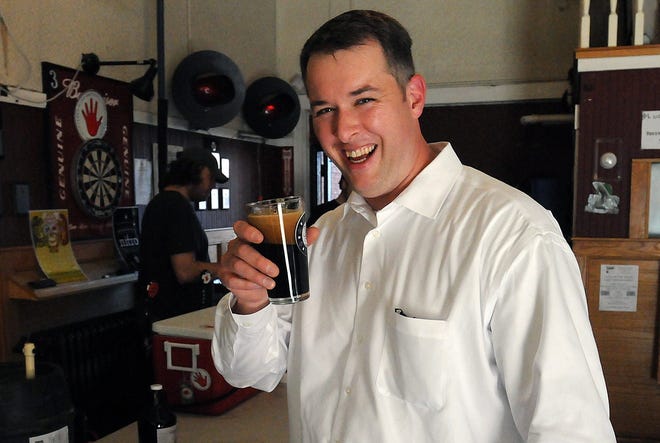 Scott Duane of Marlborough toasts to a good cause during a fundraiser for the victims of the Boston Marathon bombings, at The Tavern in Framingham, Wednesday. The event was organized by Jack's Abby Brewery with all proceeds going to the victims.