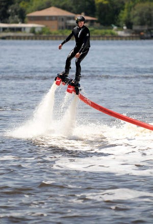 Bruce.Lipsky@jacksonville.com Chris Downer of Flyboard North Florida does a demonstration run at the Southeast U.S. Boat Show last Saturday. Downer flew around 25 feet above the St. Johns River, using the thrust from a jet ski.