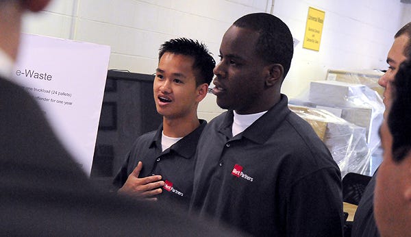 Chaderjian Youth Correctional Facility wards Thien Le, left, and Tarrance Turner, both 22, speak during a tour Thursday of the computer repair and restoration program.