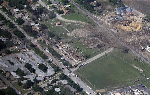 This Thursday aerial photo shows the remains of a nursing home, left, apartment complex, center, and fertilizer plant, right, destroyed by an explosion in West, Texas. (Associated Press)