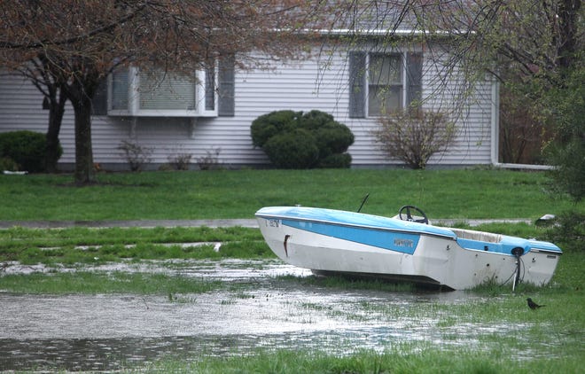 A boat lying in an open lot filled with standing water is seen along N. 28th St. off Ridge Ave. in Grandview on Thursday afternoon, April 18, 2013.