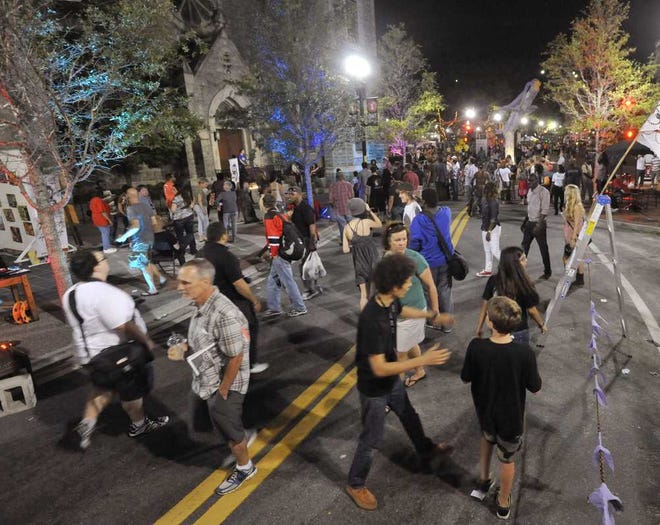 Crowds walk along Laura Street during the One Spark festival on Thursday night in downtown Jacksonville.