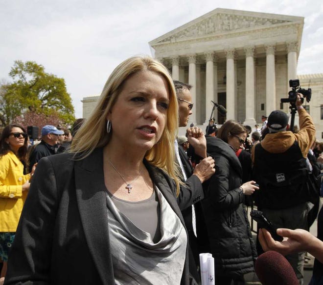 Florida Attorney General Pam Bondi speaks to reporters in front of the Supreme Court in Washington, Wednesday, March 28, 2012, on the final day of arguments regarding the health care law signed by President Barack Obama. (AP Photo/Charles Dharapak)