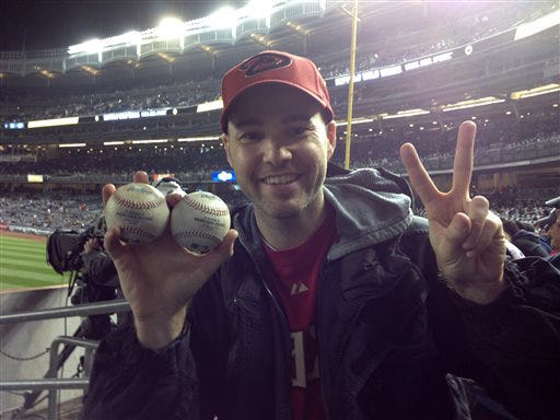 Zack Hample, a 35-year-old New Yorker holds the two balls he caught in the right-field seats Thursday during the Yankess Diamondbacks game. Hample, who wrote a how-to book about snagging big league baseballs, said he caught two home runs at a game for the second time after accomplishing the feat at Baltimore's Camden Yards on drives by Seattle's Michael Saunders and the Orioles' Corey Patterson on May 13, 2010.