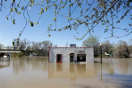 A restaurant sits surrounded by floodwater Saturday, April 20, 2013, in Louisiana, Mo. Communities along the Mississippi River and other rain-engorged waterways are waging feverish bids to hold back floodwaters that may soon approach record levels.