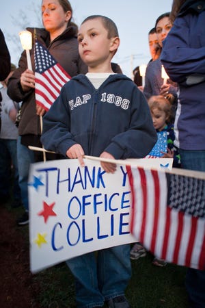 Joseph Marriott, 7 of Pepperell, holds a sign at a vigil for Sean Collier, the MIT police officer killed in the line of duty Thursday by the Marathon bombers who was a Wilmington native and Somerville resident, on Saturday, April 20, 2013 in Wilmington Town Common.

Photo by Zara Tzanev
