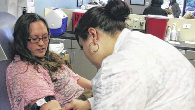 Technician Felicia Castillo, at the Blood Center of Central Texas’ Round Rock location, prepares to draw a pint of blood from Jessica Garcia of Georgetown. Garcia was one of the dozens of people who turned out at the Blood Center Thursday, following Wednesday’s fertilizer factory explosion in Waco.