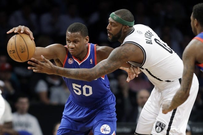 The Sixers' Lavoy Allen (50) tries to keep the ball from the Nets' Andray Blatche during an April 9 game in Brooklyn.