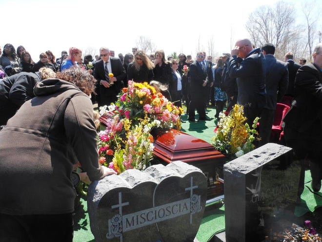 Loved ones crowded around the casket of Krystle Campbell to leave flowers and say their final farewells at Oak Grove Cemetery on Monday afternoon.