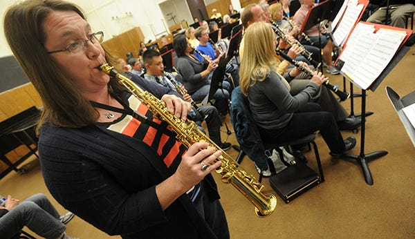 Cathy Ettle plays her saxophone during Delta Winds & Stockton Wind Ensemble rehearsal Tuesday night at San Joaquin Delta College.