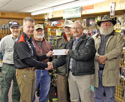 MIKE MCKEE/ The Evening News
Terry Sanderson of Leitz Sport Center presents President Damon Lieurance of the Chippewa County Shooting Association with an $8,000 check while Brian Harrison, Larry Stam, Jim Roo and Leo Joutsie look on. The funds will go towards upgrading and expanding the existing facility.