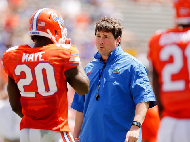 Florida coach Will Muschamp talks with player Marcus Maye during the Orange and Blue Debut at Ben Hill Griffin Stadium on April 6.