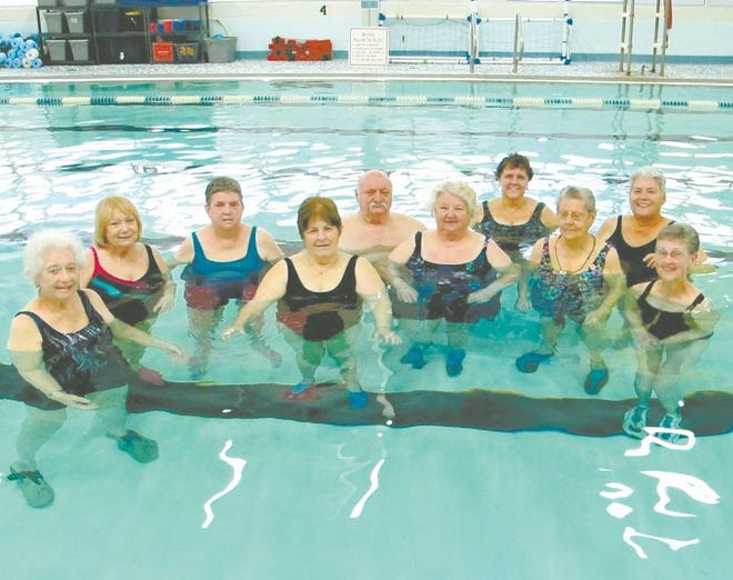 Members of the Arthritis Water Fitness Class pose after their workout. Many say the class keeps their joints moving, and allows them to work their muscles without the pain.