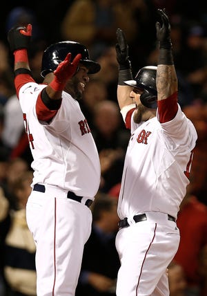 Red Sox first baseman Mike Napoli (right) celebrates with David Ortiz after hitting a grand slam during the fifth inning of Boston's 9-6 win over the A's on Monday night.