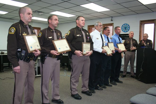 From left to right: Cheboygan County Sheriff’s Department deputies Jeffrey Bur, Ronald Fenlon and Joshua Ginop, as well Cheboygan County Search and Rescue Unit deputies Daniel Socha, Matthew Drake and Joe Lavender, received life-saving awards Tuesday from Cheboygan County Sheriff Dale Clarmont and Emmet County Sheriff Pete Wallin (representing the Michigan Sheriff’s Association) during the Cheboygan County Board of Commissioners meeting.