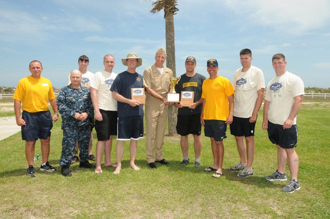 USS Vicksburg receives the First Place trophy as the winners of the 2013 MWR Spring Sports Challenge, beating out 21 other commands.