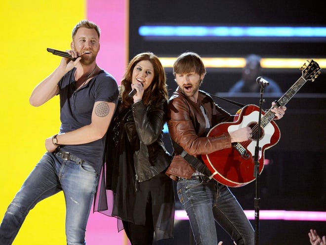 Members of the band Lady Antebellum, from left, Charles Kelley, Hillary Scott and Dave Haywood perform at the 48th Annual Academy of Country Music Awards in Las Vegas. The iTunes music store changed how we consume music and access entertainment. Lady Antebellum's entire career has been in the iTunes era, and it's a key part of their sales.
(CHRIS PIZZELLO | INVISION VIA THE ASSOCIATED PRESS)