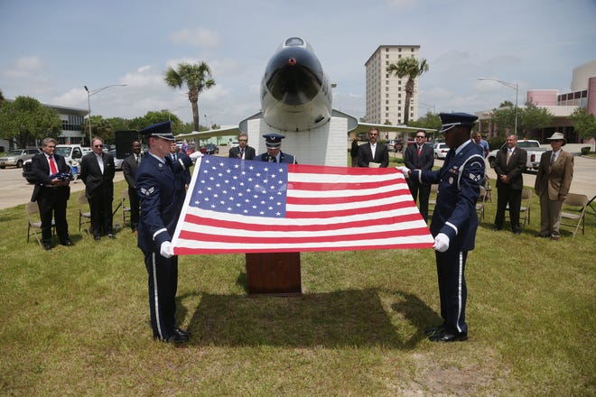 Members of the Tyndall Air Force Base Color Guard fold a flag during a ceremony to retire the F-101 Voodoo jet at the Panama City Marina on Wednesday.