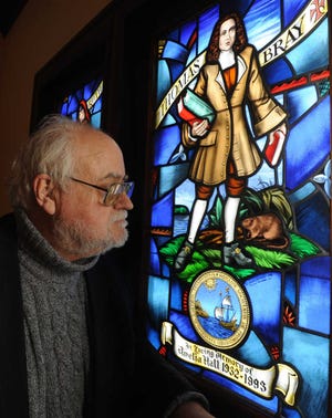 ADVANCE FOR SUNDAY APRIL 21 - In this Jan. 25, 2013 photo, Father Nathaniel Pierce examines the details of a stained glass window in St. Philip's Episcopal Church in Quantico, Md. that features a muskrat. (AP Photo/The Daily Times, Brice Stump) NO SALES