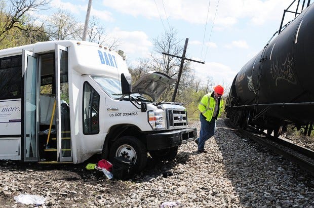 Buffalo and Pittsburgh Railroad Superintendent John Pope of Butler inspects the BART vehicle that was struck by a train Friday in Evans City.