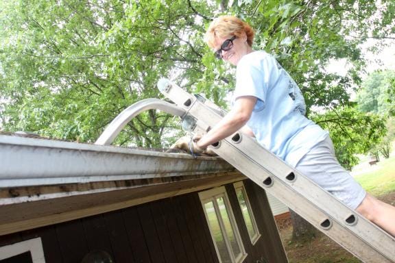 This Friday and Saturday, 80 choir members from Spring Valley Baptist Church in Columbia, S.C., will travel to Cleveland County to not only perform a musical but to get their hands dirty working in the community. In this file photo, Ashley Smith cleans out the gutters of a home that as a part of Operation In As Much, a similar event held every other year in Cleveland County. (Ben Earp / The Star)


Image Description - Ashley Smith cleans out the gutters of a home that as a part of Dover Baptist Church's Operation in as Much. (Ben Earp/The Star)