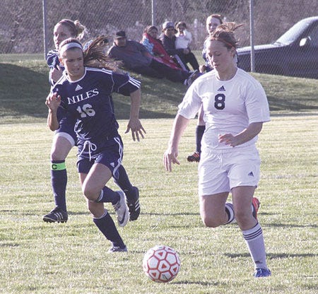 Alea Penner moves in to score the Lady Trojans’ first goal of the night Friday. Penner added another first-half goal.