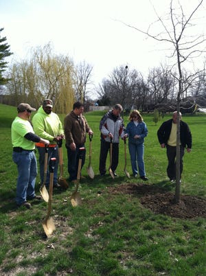 City officials and attendees plant a new black tupelo tree Friday, April 26, 2013, during an Arbor Day celebration off Newburg Road in Rockford.