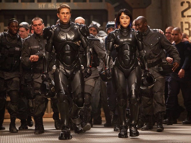 Charlie Hunnam, left, as Raleigh Becket, and Rinko Kikuchi as Mako Mori in “Pacific Rim.” (The Associated Press/Warner Bros. Pictures)