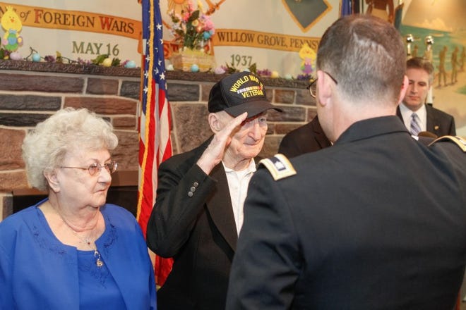 World War II vet, Walter Czerviski, 92, salutes as he receives several medals for his Navy service 70 years ago. His wife, Jackie, is by his side.