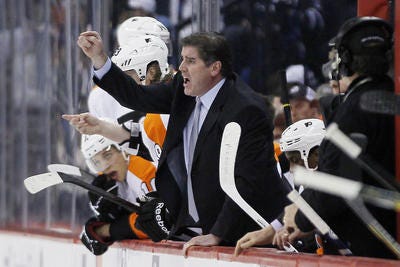 Philadelphia Flyers head coach Peter Laviolette yells to his players during the second period of their NHL game against the Winnipeg Jets in Winnipeg on Saturday, April 6, 2013. (AP Photo/The Canadian Press, John Woods)