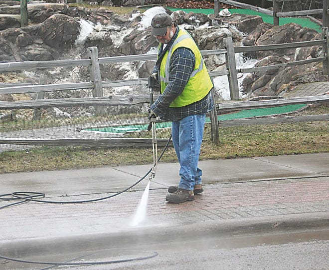 After an extended season of plowing snow, this seasoned veteran, Randy Stoling, said the chance to hose down the decorative brick along W. Portage was a welcome change of pace early today. The high pressure water stream was sent in to remove the accumulated sand, salt and grime left behind by the recent melt-off.