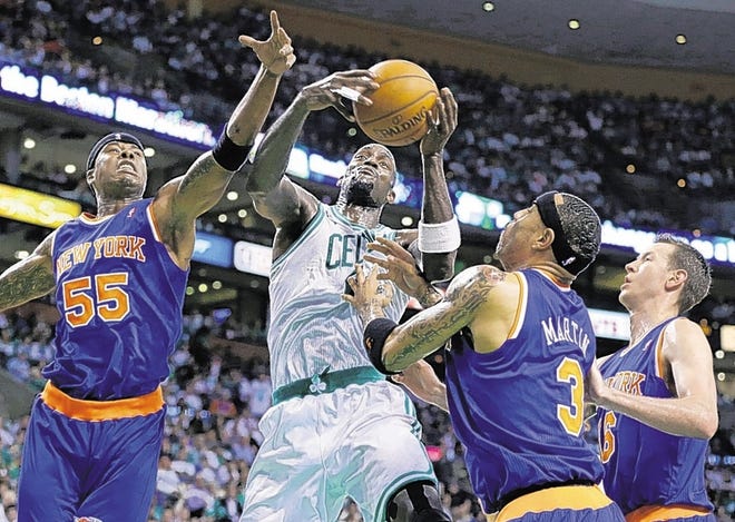 Celtics' Kevin Garnett, second from left, pulls down an offensive rebound against Quentin Richardson, left, Kenyon Martin (3) and Steve Novak during the first half on Sunday in Boston.