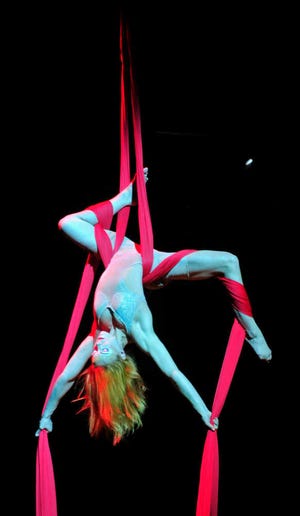 Julie Cameron performs the "Aerial Contortion in Silk." Quidam is a story about Zoé, a bored young girl that escapes into a world of imagination.