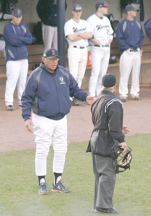 Recently retired Eastern Connecticut State University coach Bill Holowaty (left) discusses a call with an umpire during a game in April 0f 2012.