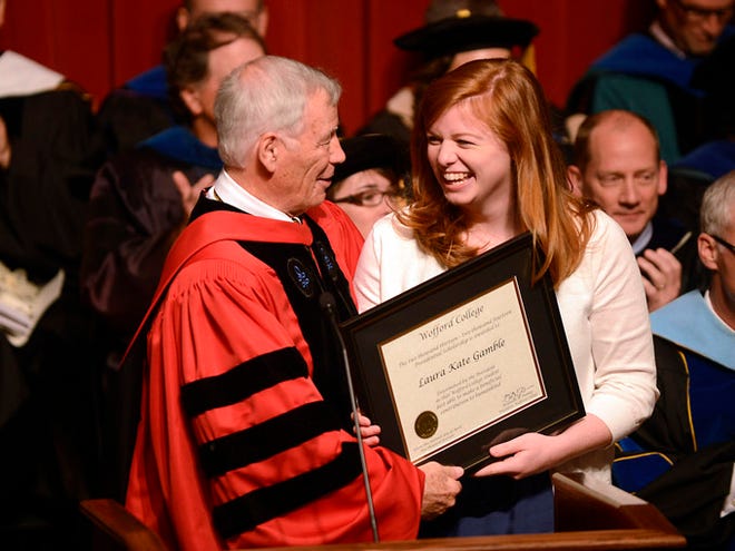 Wofford President Benjamin Dunlap presents Laura Kate Gamble, of Summerville, with the college’s Presidential International Scholar award Tuesday.