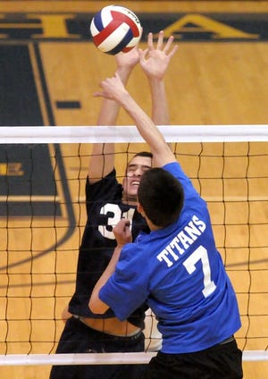 The Council Rock High School South Golden Hawks host a boys volleyball game against the Central Bucks South Titans on Monday afternoon. Here Titans Aleck Mayhew spikes the ball past Hawks Jake Sweed in the second match.
