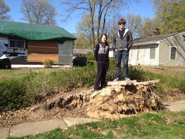 Kate McGarvey, 16, and her brother John, 15, stand of torn sidewalk in front of their storm-damaged home in the Thornridge section of Levittown. Superstorm Sandy's 70 m.p.h. gusts knocked down bout 50 of the neighborhood's stately oaks, some of them landing on top of homes that had to be abandoned.