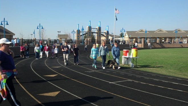 Parents, students and supporters gather at the Ionia High School track April 27 for the Autism Awareness Walk.