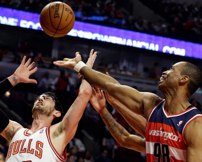 Washington Wizards center Jason Collins, right, battles for a rebound against Chicago Bulls guard Kirk Hinrich during the first half of an NBA basketball game in Chicago on April 17.