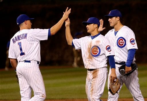 Chicago Cubs third baseman Cody Ransom, second baseman Darwin Barney, center, and first baseman Anthony Rizzo celebrate the Cubs' 5-3 win over the San Diego Padres after a baseball game, Monday, April 29, 2013, in Chicago. (AP Photo/Charles Rex Arbogast)